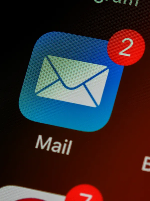 Blue mail app icon with two unread messages shown by red notification badge on smartphone screen.