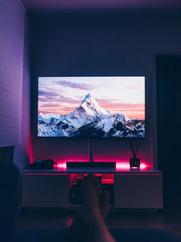 a person's feet in front of a television screen