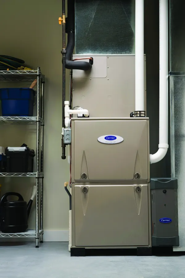 Well-maintained furnace and utility shelves in a tidy garage setting, showcasing organized storage.