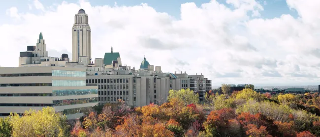 a flag flying in front of a clock tower