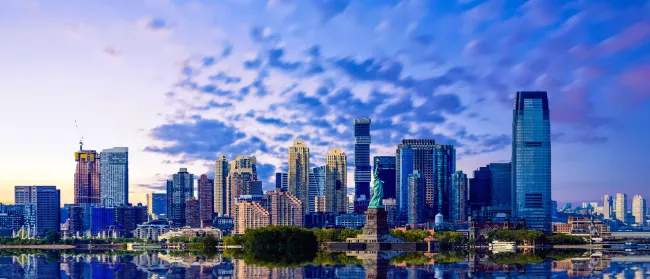 a city skyline with a body of water in front of it