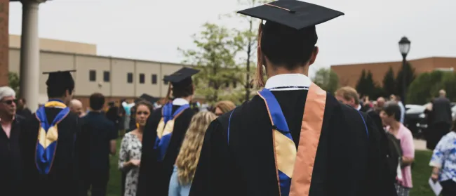 a group of people in graduation gowns and caps