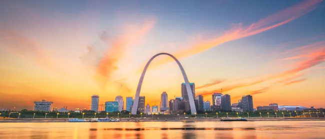 a city skyline with a rainbow