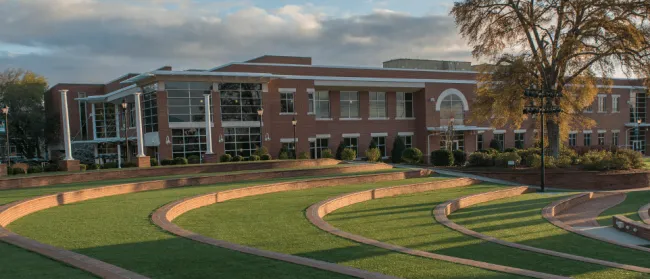 a large building with a green lawn