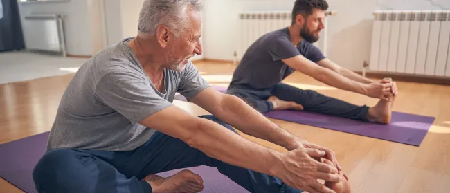 a man and a woman doing yoga