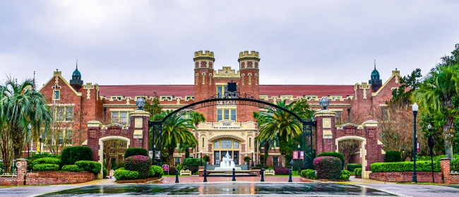 a large building with palm trees in front of it