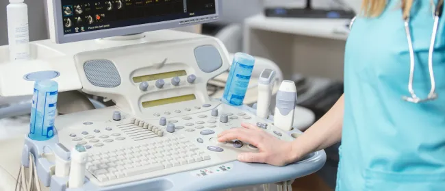 a person in a medical scrubs working on a computer