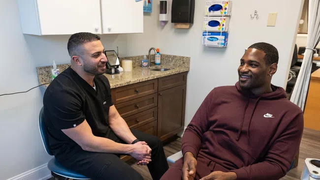 Healthcare professional talking with patient in a modern medical office during consultation.
