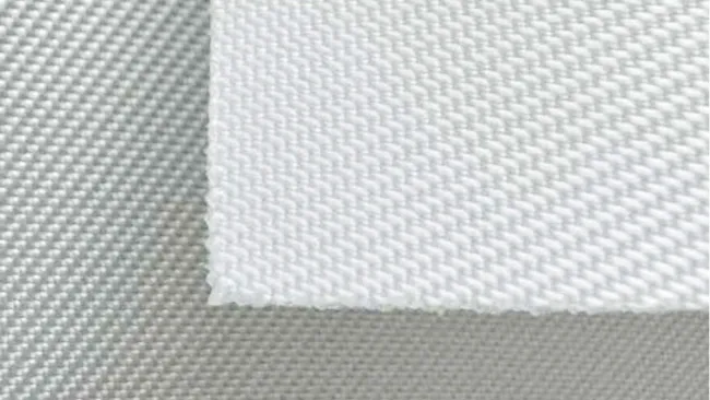 Close-up of white textured fabric with detailed weave pattern on different layers.