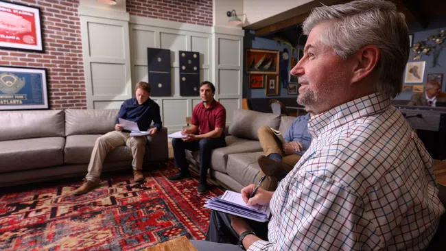 a group of people sitting in a living room