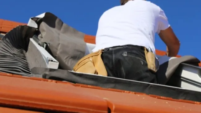 Forsyth Exteriors' contractors installing a skylight to an Atlanta home