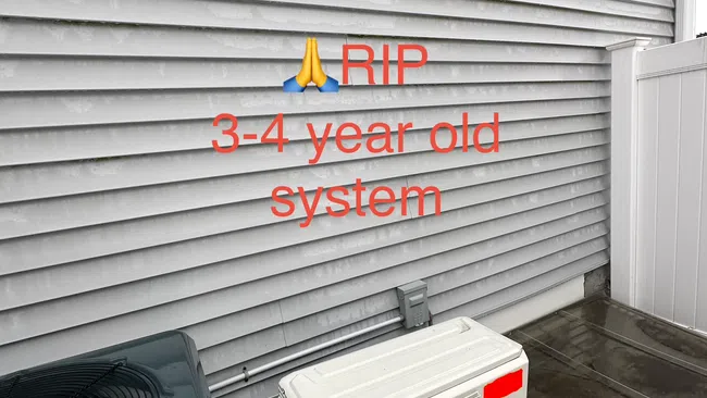 Outdoor HVAC units beside a house with gray siding and two small windows, with text about a 3-4 year old system.