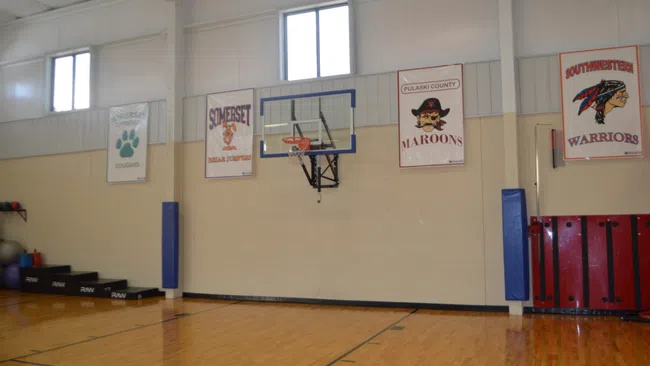a basketball court with posters on the wall