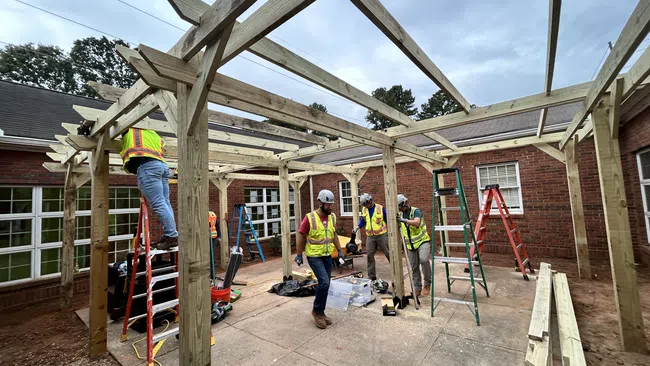 a group of men working on a house under construction