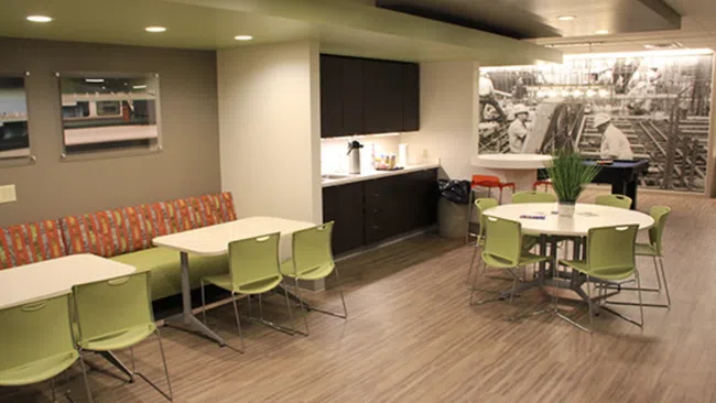 a room filled with furniture and a large screen
