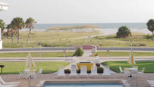a pool with chairs around it