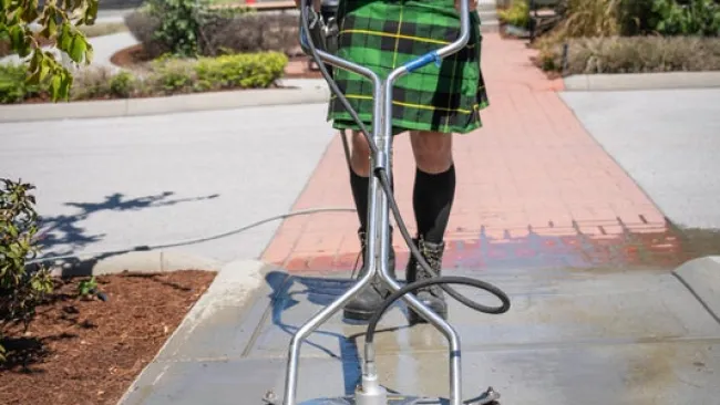 a man wearing a hat and holding a shopping cart