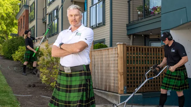 a person in a kilt holding a hose