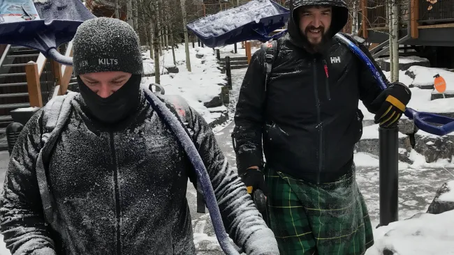 two men standing in the snow