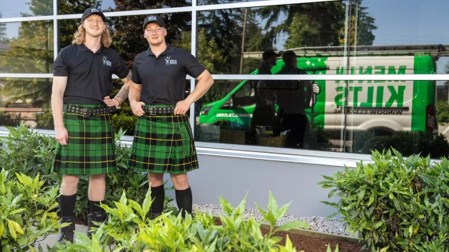 a couple of men standing in front of a building