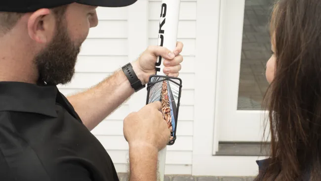 a man holding a gutter camera