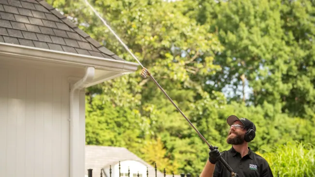 a person holding washing a house