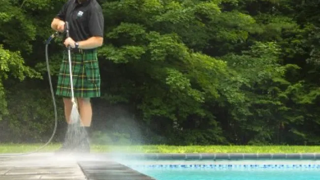 a man standing next to a pool