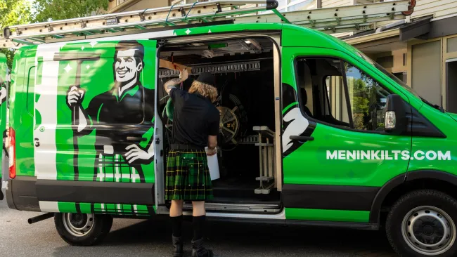 a person standing next to a green van