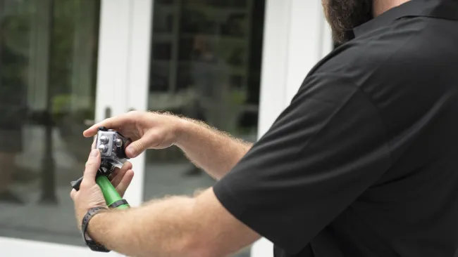 a man holding a gutter camera