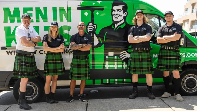 a group of people wearing kilts