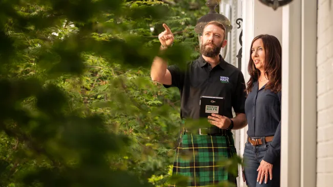 a man and a woman standing outside a house