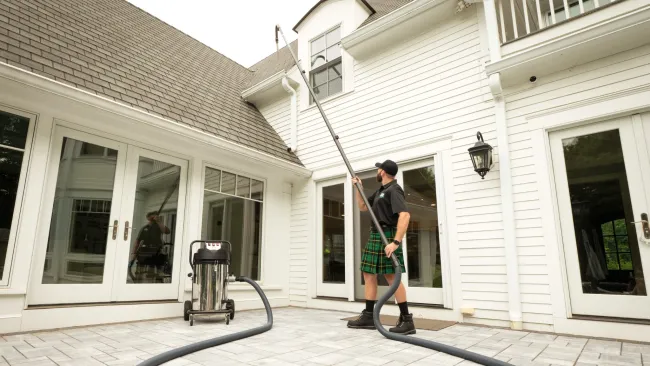 a person cleaning gutters