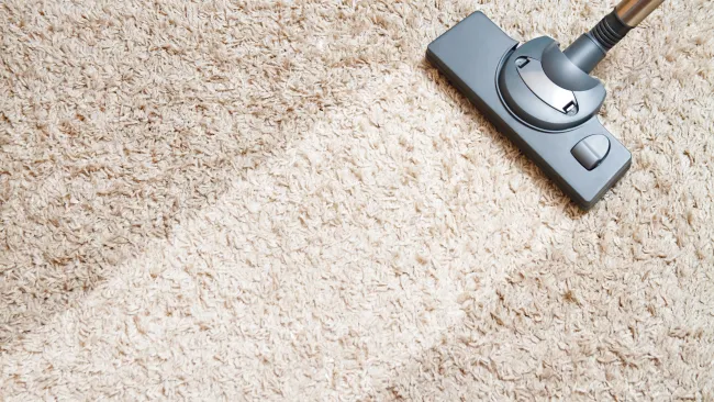 a black and silver stapler on a carpet