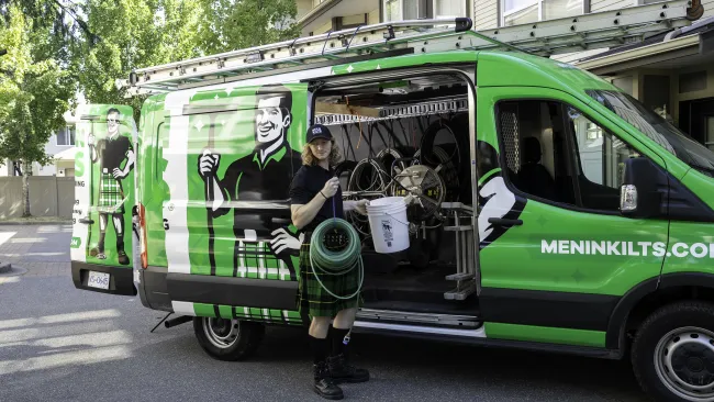 a person standing next to a green van