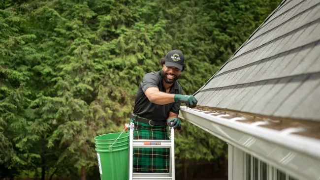 a person holding a green bucket