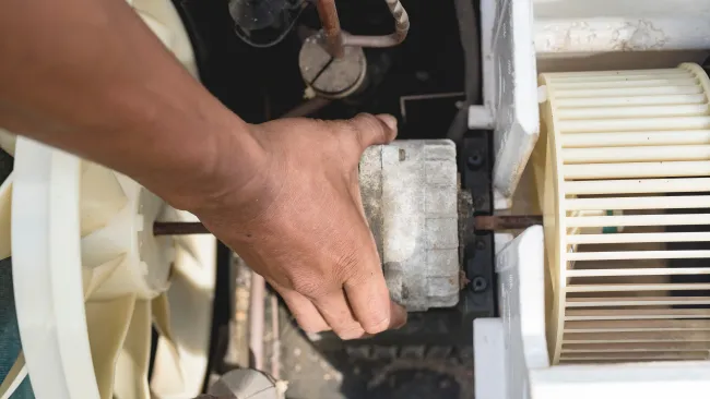 a person holding a piece of metal