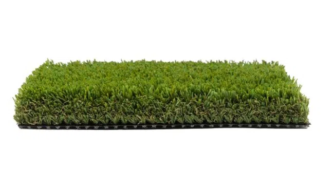 Rectangular sample of dense artificial green grass turf on a flat surface with black backing.
