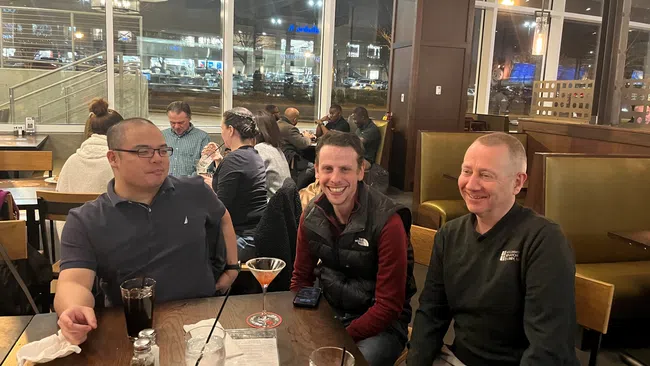 a group of people sitting at a table with drinks