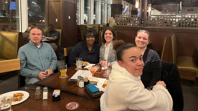 a group of people sitting at a table