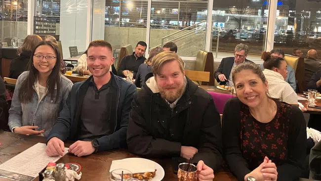 Koven Smith et al. sitting at a table
