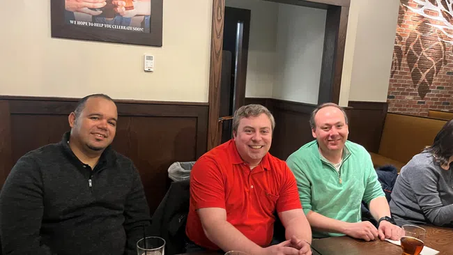 a group of men sitting at a table