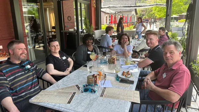 a group of people sitting around a table