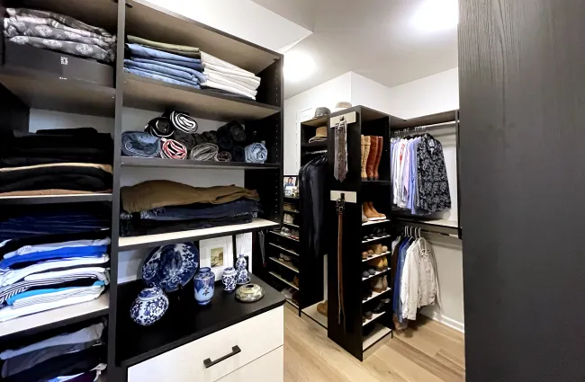 a closet with clothes and shoes