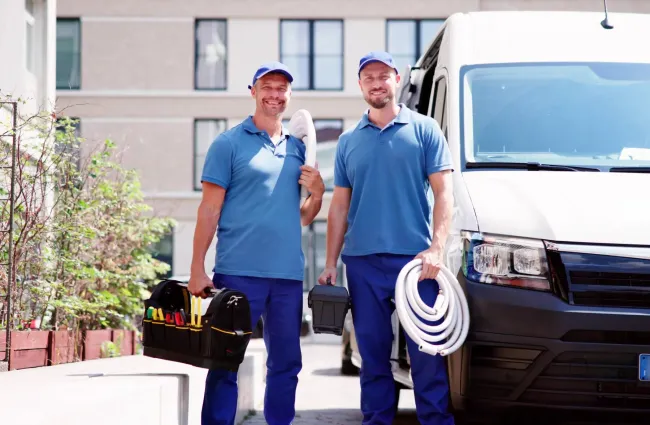 a couple of men carrying luggage