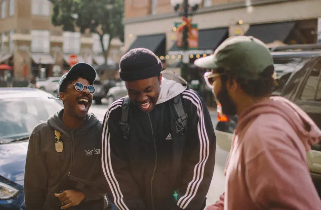 a group of men standing on a sidewalk