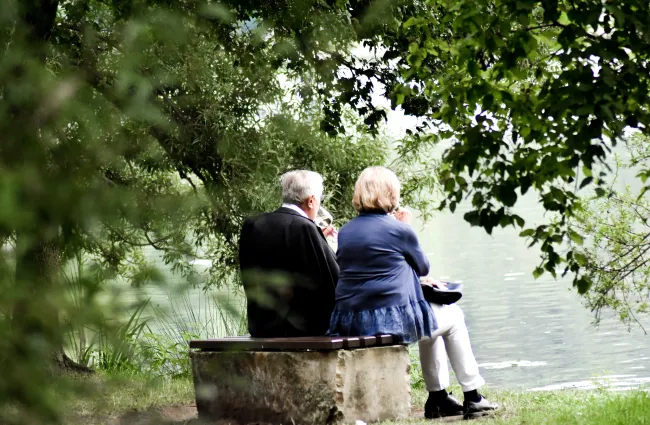 an older couple looking at a lake