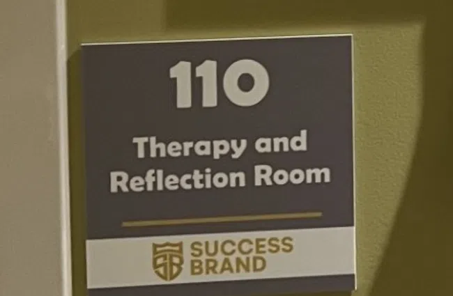 Community bulletin board with job listings and career resources in a therapy and reflection room corridor.