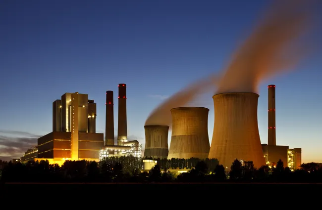 a factory with smoke stacks