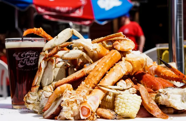 a crab on a table next to a pile of fries