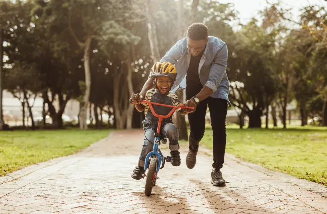 Split Custody - Dad Playing with son riding a bike